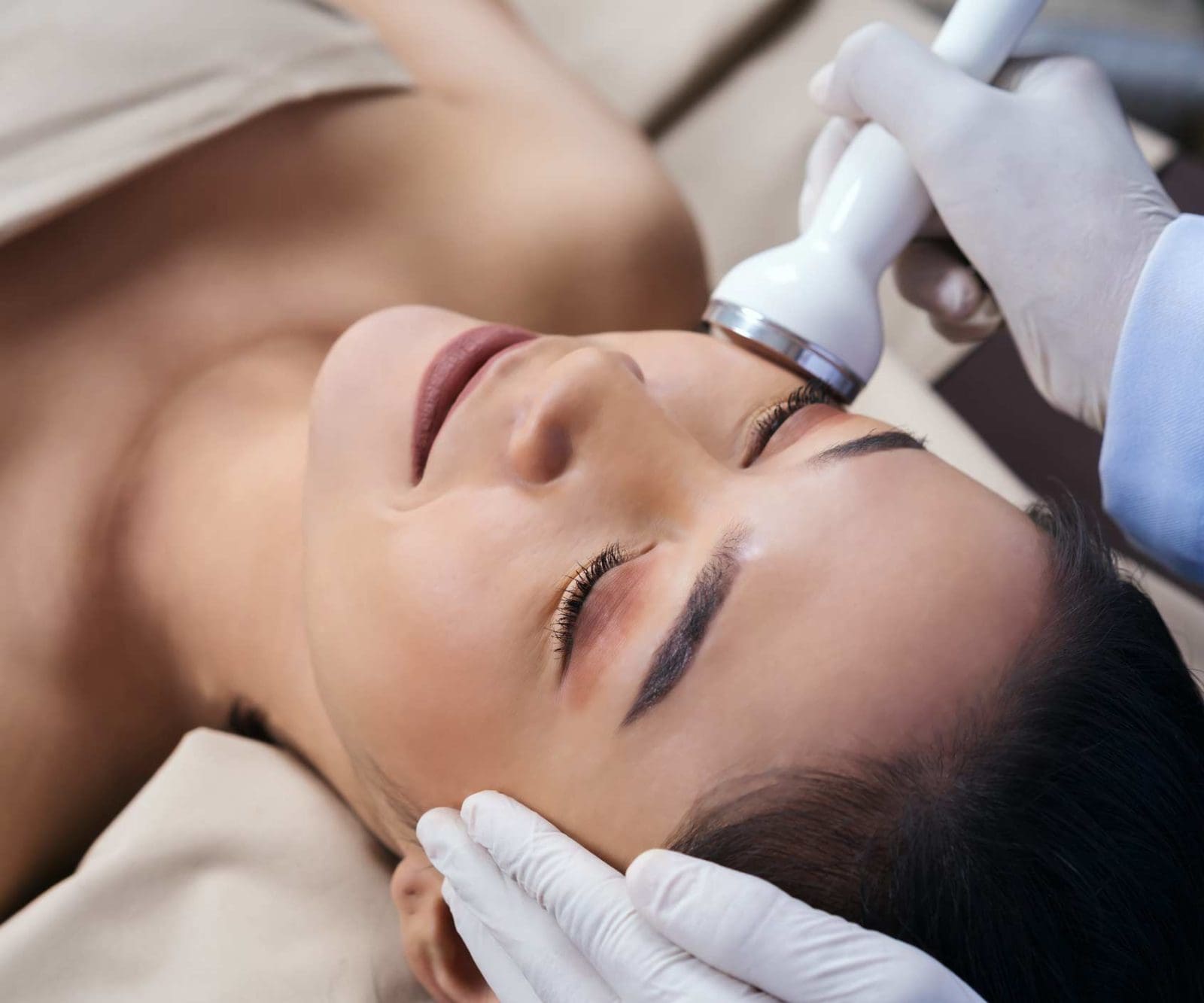 Junge Frau bei einer Ultraschallbehandlung im Gesicht im Bodyshape Kosmetikstudio München
